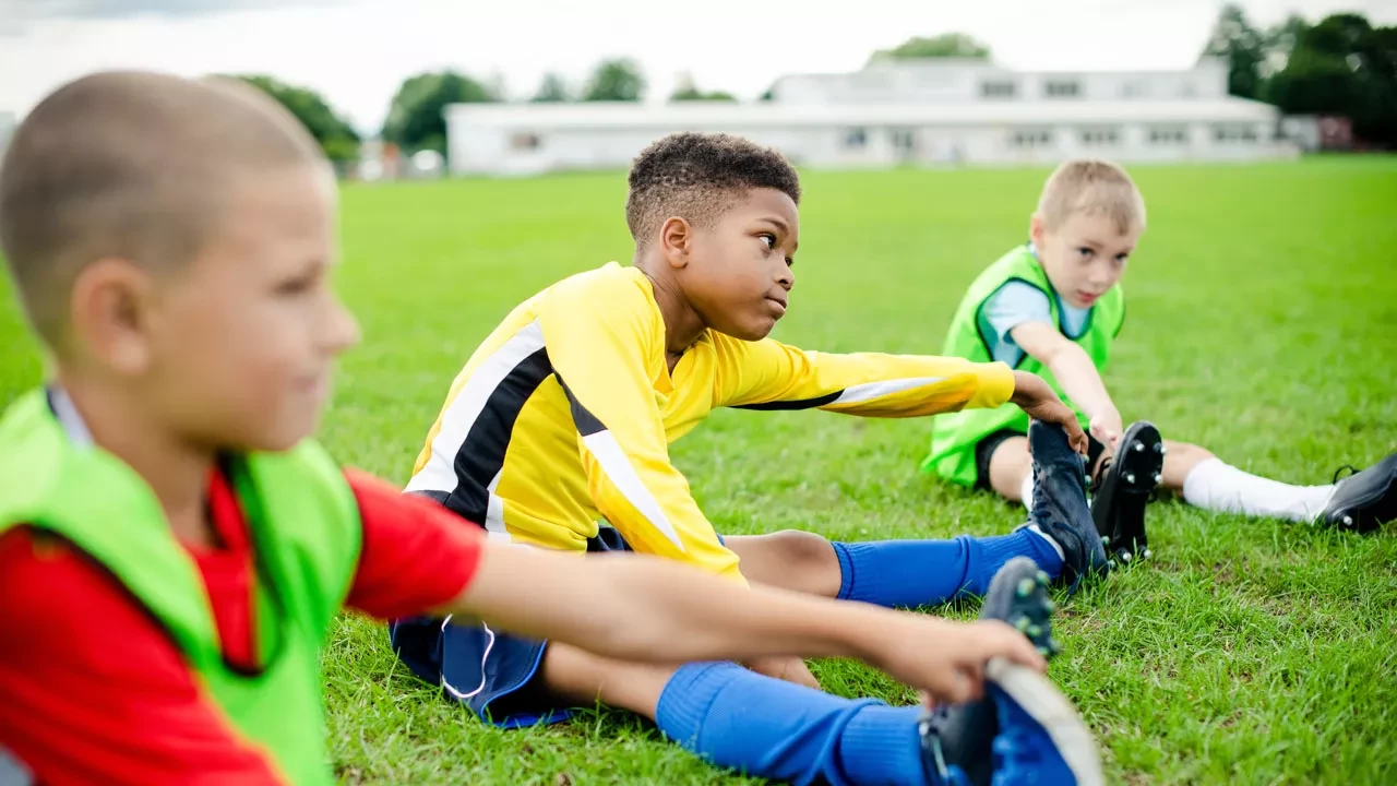 youth soccer players stretching