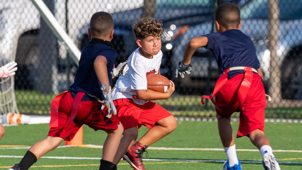 youth playing flag football