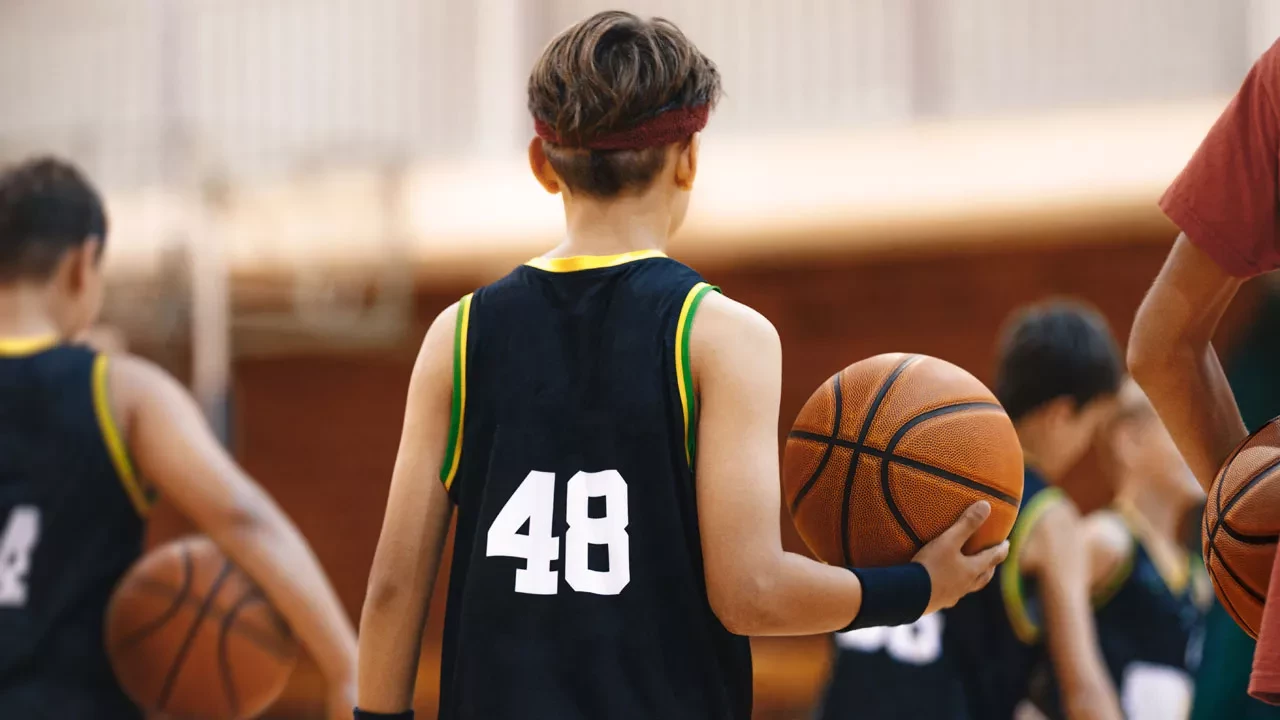 youth basketball player holding a basketball